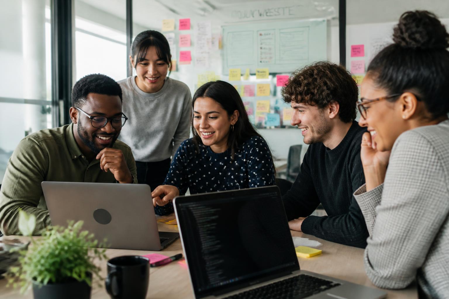 A diverse team of designers and developers building a website together
